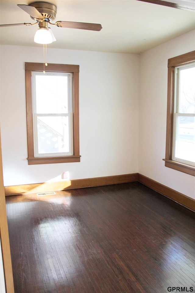 empty room featuring ceiling fan and dark hardwood / wood-style floors