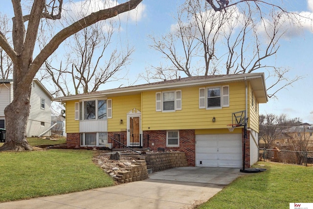 split foyer home with brick siding, driveway, a front lawn, and fence