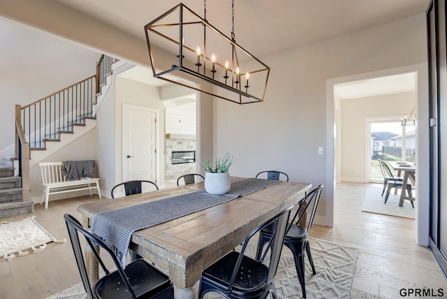 dining area with a notable chandelier and light hardwood / wood-style floors