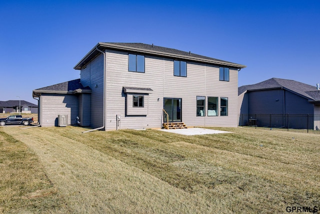 rear view of property featuring central AC, a patio, and a lawn