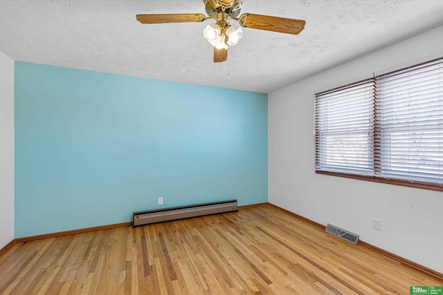 empty room with ceiling fan, a baseboard radiator, a textured ceiling, and light wood-type flooring