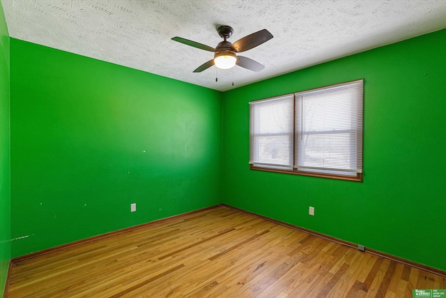 unfurnished room featuring ceiling fan, light hardwood / wood-style flooring, and a textured ceiling