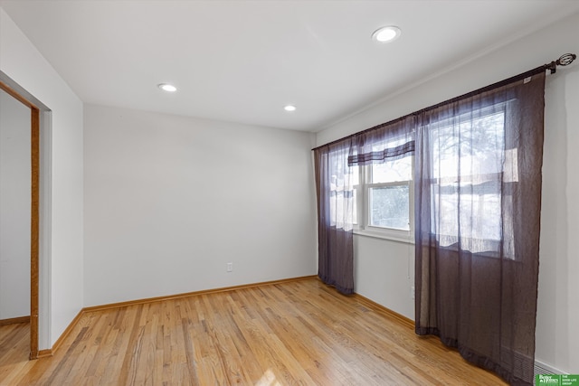 spare room with light hardwood / wood-style flooring