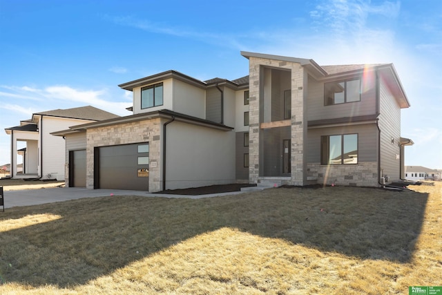 view of front of home with a garage and a front yard