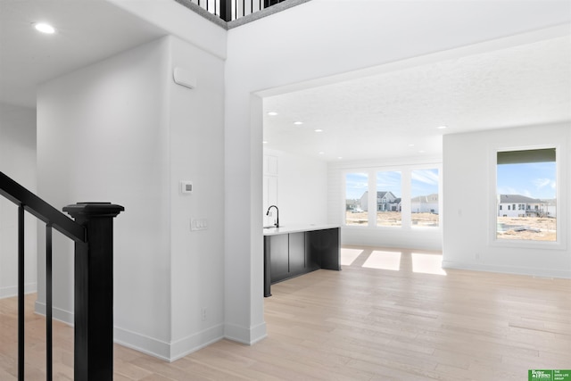 interior space with sink and light wood-type flooring