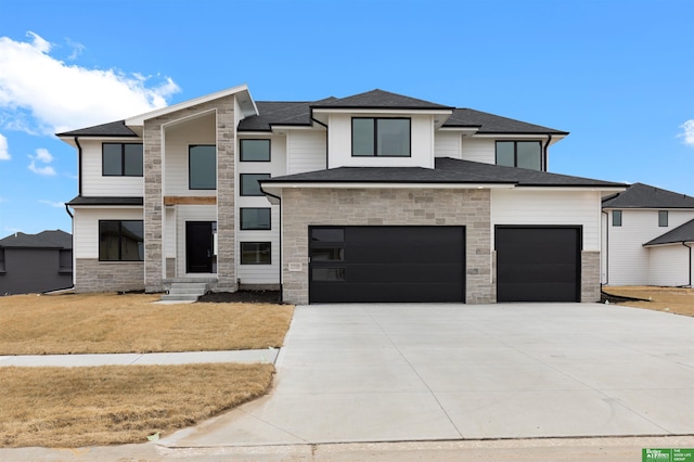 view of front of home with a garage and a front yard