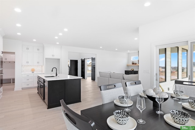 dining area featuring sink and light hardwood / wood-style floors