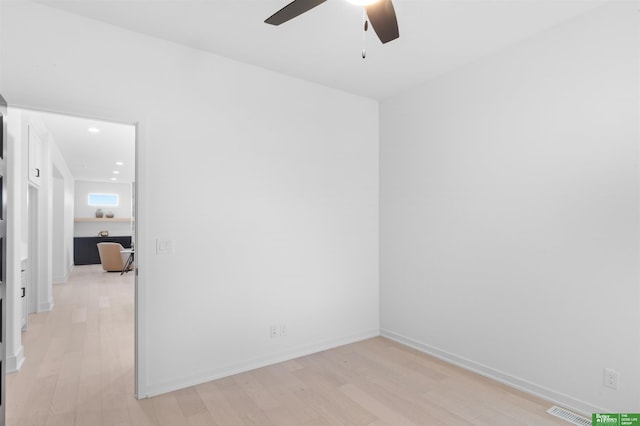 empty room featuring ceiling fan and light hardwood / wood-style flooring