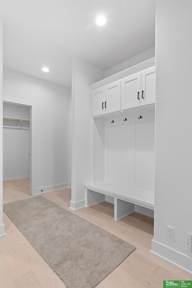 mudroom with light hardwood / wood-style floors