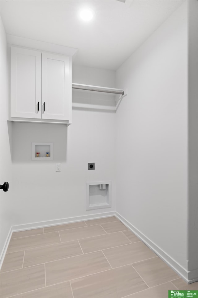 clothes washing area with hookup for a washing machine, electric dryer hookup, and cabinets