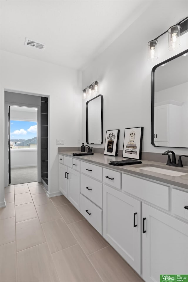 bathroom featuring tile patterned flooring and vanity