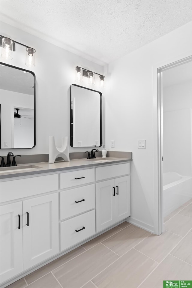 bathroom featuring vanity and a textured ceiling