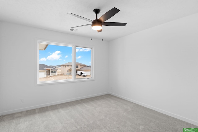 carpeted empty room featuring ceiling fan