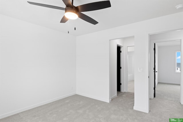 empty room with light colored carpet and ceiling fan