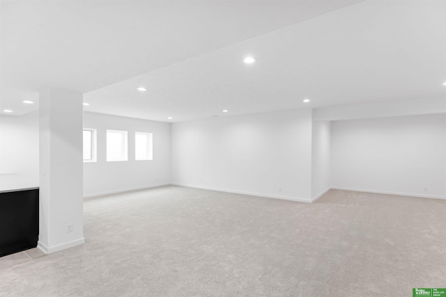 basement featuring light colored carpet