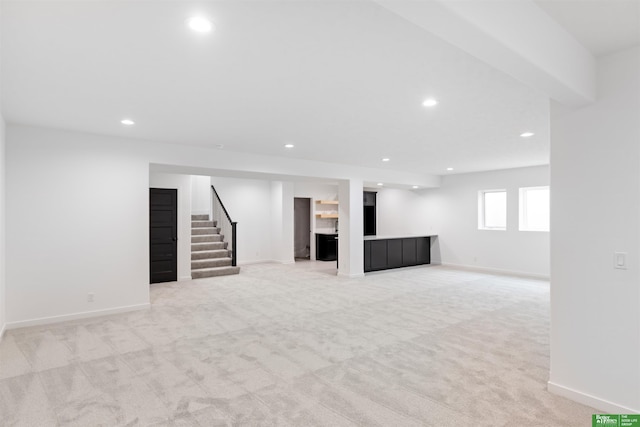 basement featuring light colored carpet