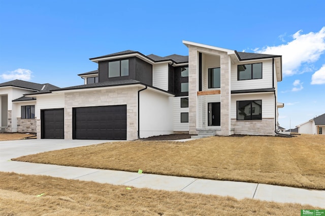 view of front of property featuring a garage and a front yard