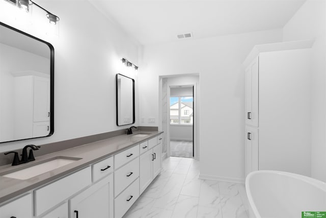 bathroom with vanity and a tub