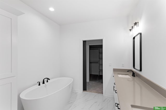 bathroom featuring vanity and a tub