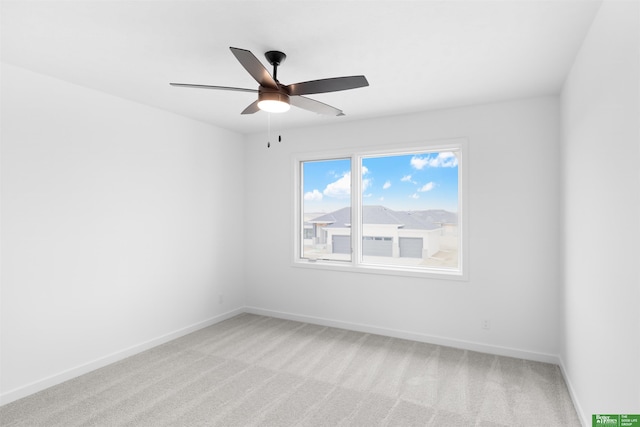 unfurnished room featuring ceiling fan and carpet flooring