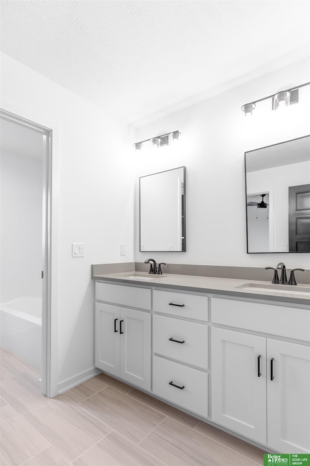 bathroom with vanity and a textured ceiling