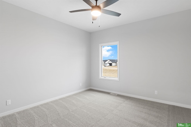 empty room with ceiling fan and carpet