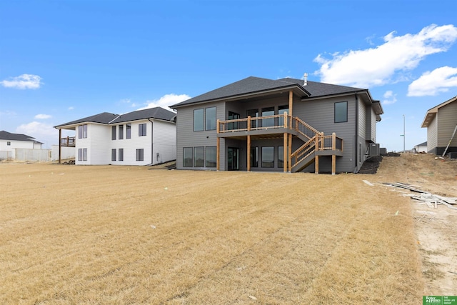 back of house featuring a lawn