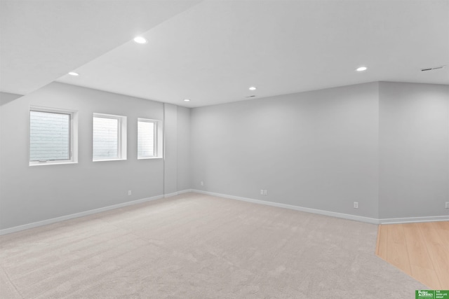 spare room featuring light colored carpet