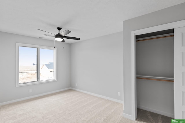 unfurnished bedroom with light colored carpet, a closet, and ceiling fan