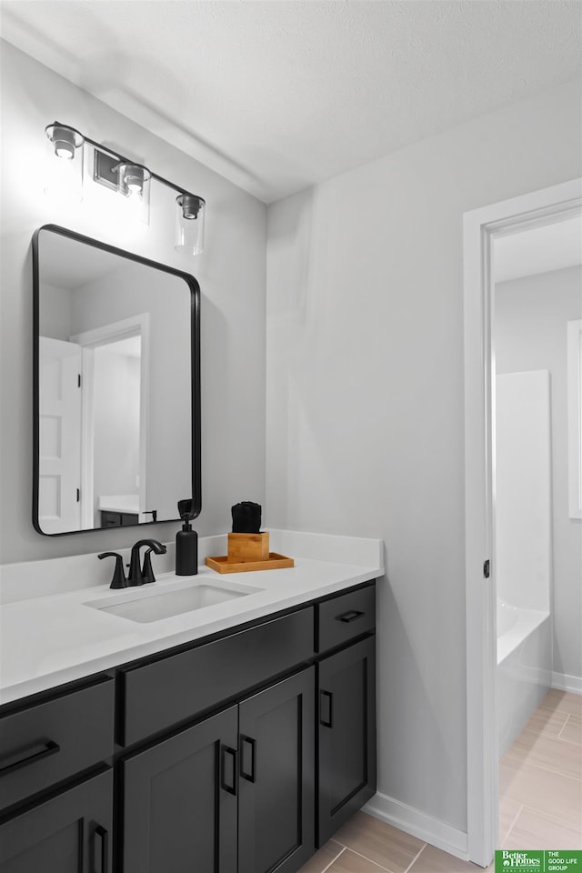 bathroom featuring vanity and a bath