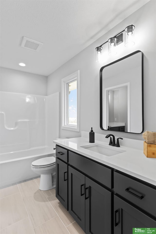 full bathroom with vanity, shower / bathing tub combination, a textured ceiling, and toilet