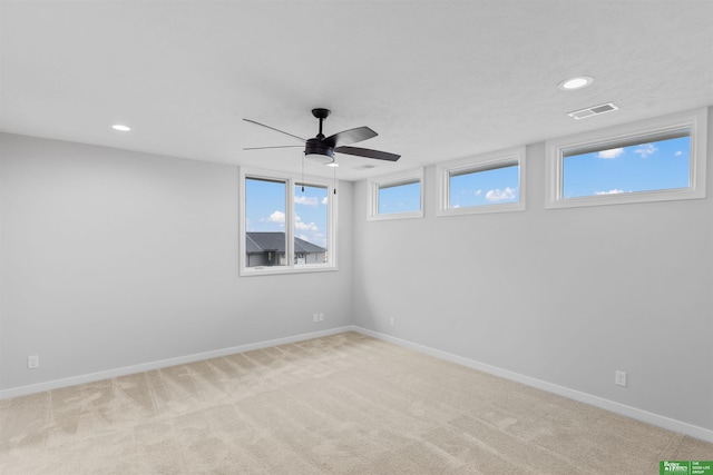 carpeted empty room featuring ceiling fan