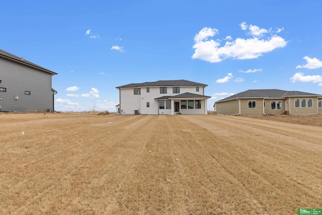 rear view of property with a yard