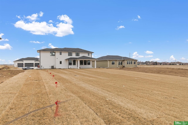 rear view of property featuring a lawn