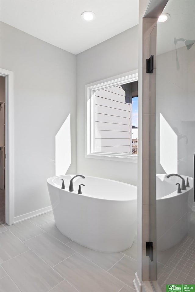 bathroom featuring shower with separate bathtub