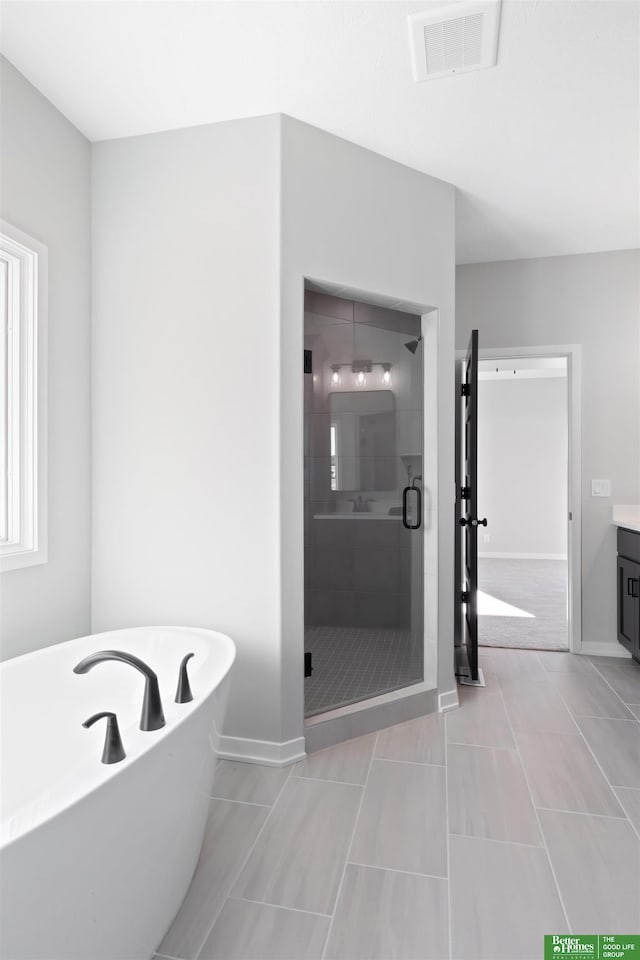 bathroom with vanity, shower with separate bathtub, and tile patterned flooring