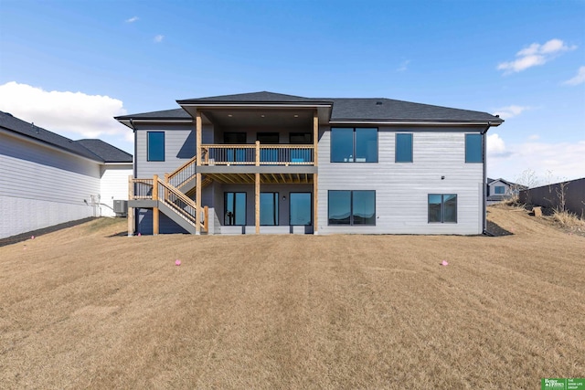 back of property featuring central AC and a lawn