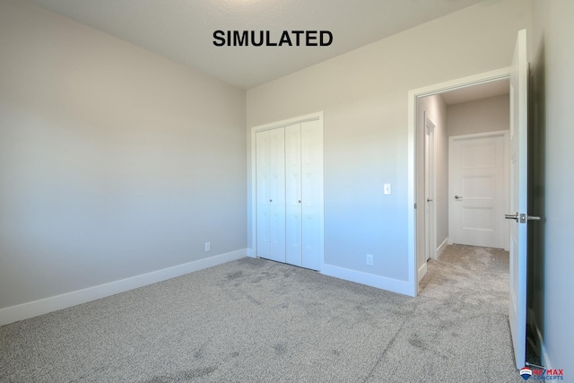 unfurnished bedroom featuring light colored carpet and a closet