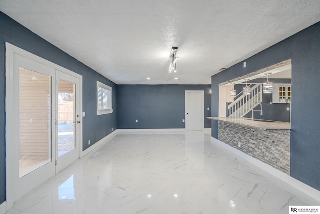 spare room with a textured ceiling