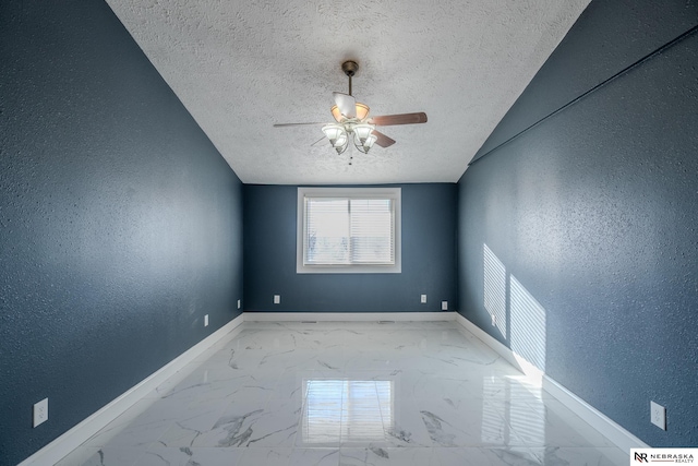 unfurnished room with ceiling fan and a textured ceiling