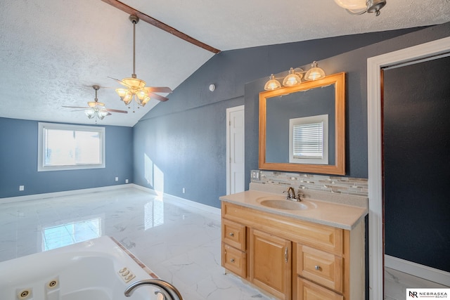 bathroom with lofted ceiling, a textured ceiling, a washtub, vanity, and backsplash