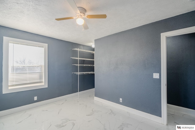 unfurnished room featuring a textured ceiling and ceiling fan