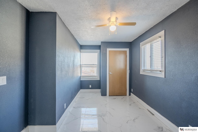 hallway with a textured ceiling