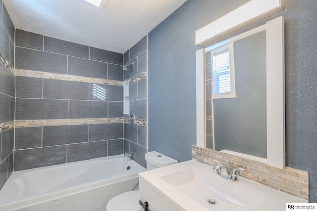 full bathroom with tasteful backsplash, vanity, toilet, and tiled shower / bath combo