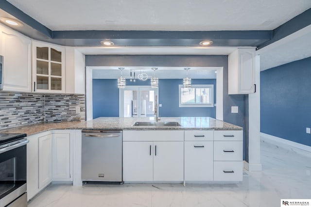 kitchen with white cabinetry, sink, decorative light fixtures, and appliances with stainless steel finishes