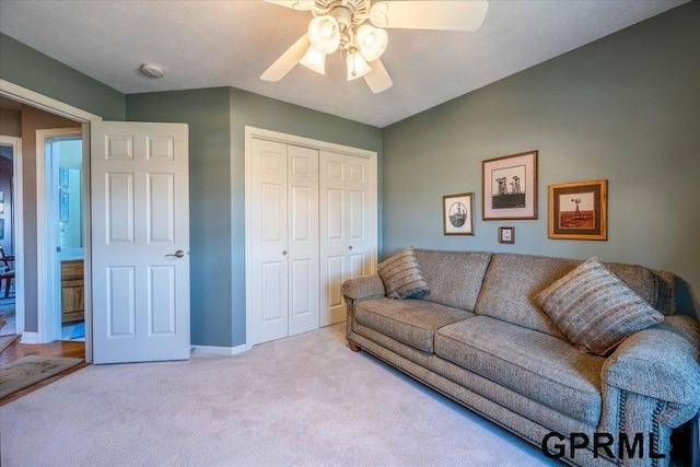 living room featuring ceiling fan and light colored carpet