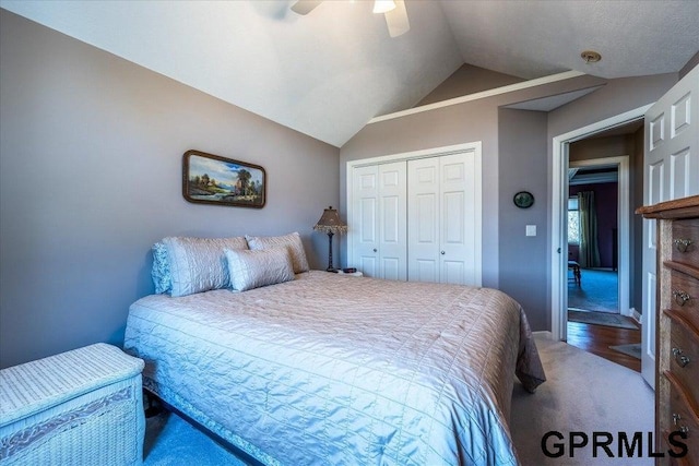 bedroom featuring carpet floors, vaulted ceiling, a closet, and ceiling fan