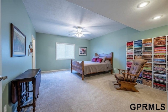 bedroom with ceiling fan, carpet, and a textured ceiling