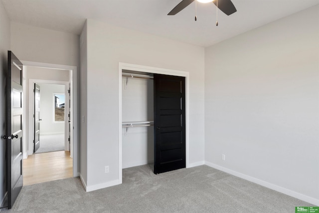 unfurnished bedroom featuring light colored carpet, ceiling fan, and a closet