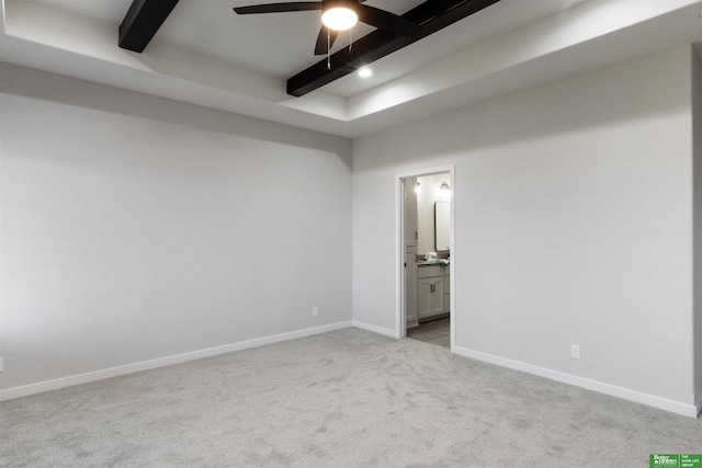 carpeted spare room with ceiling fan and beamed ceiling